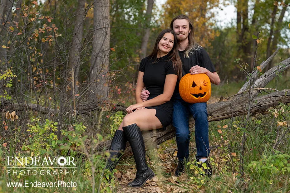 a couple sitting at Dixon Reservoir in Fort Collins Colorado with a jack-o-lantern
