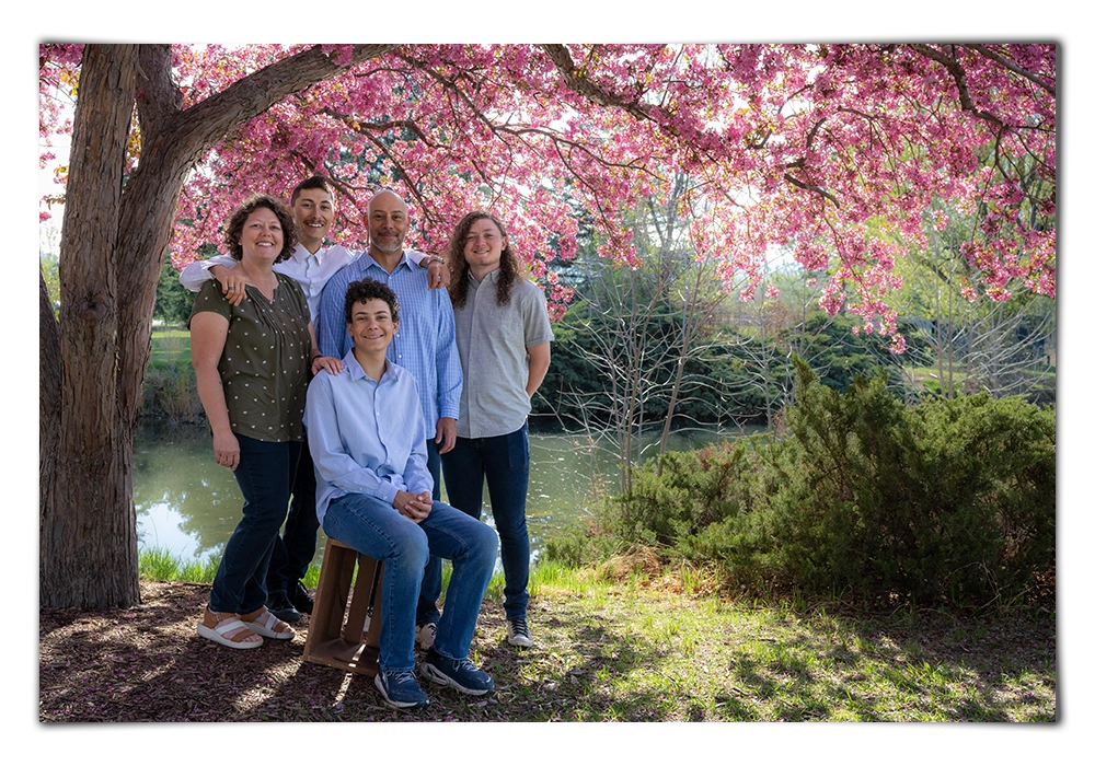 family photo under blooming crabapple tree at rolland moore park fort collins colorado